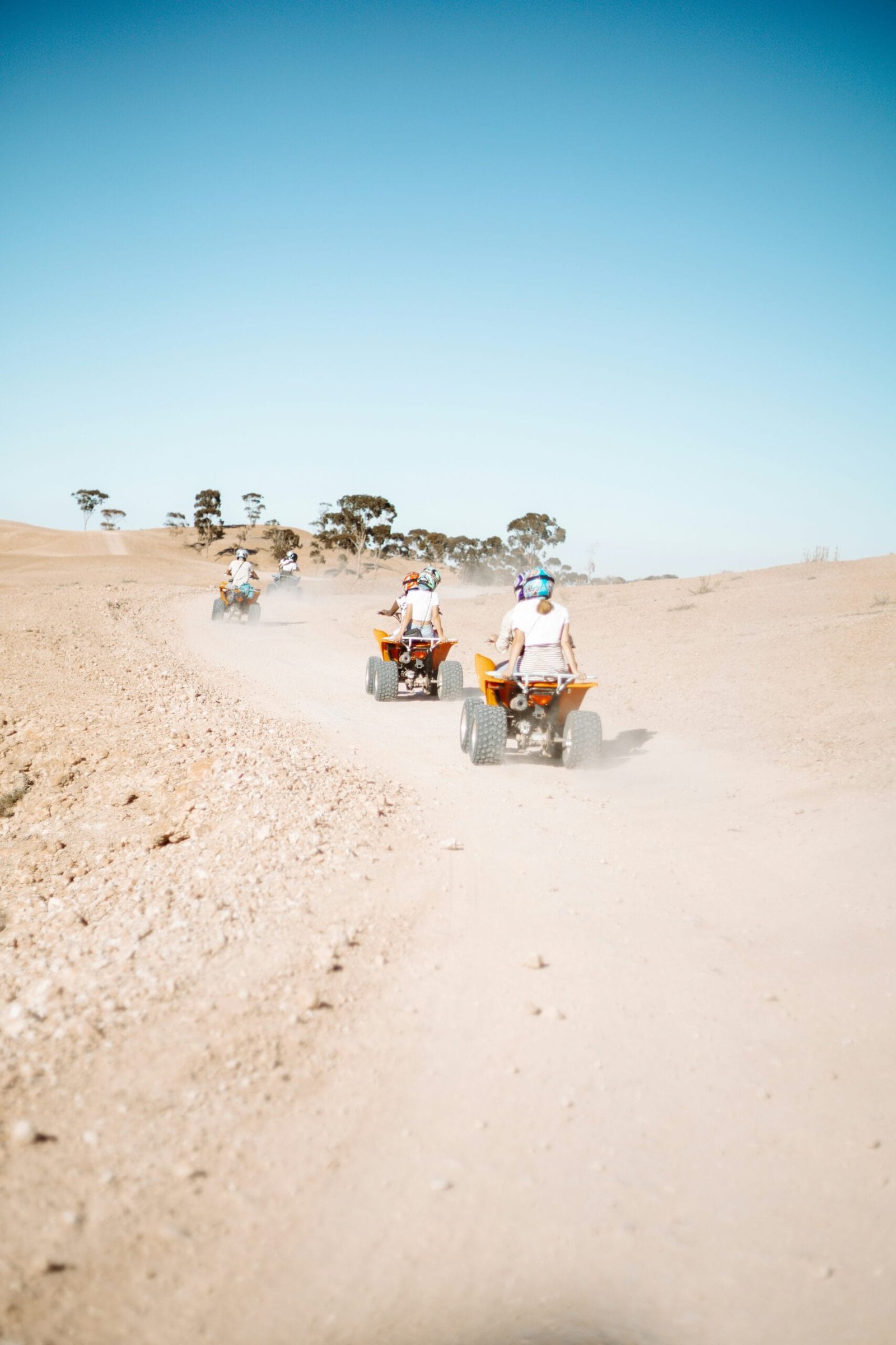 Tourist enjoying a quads bike in the Agafay Desert during a traditional Moroccan desert experience