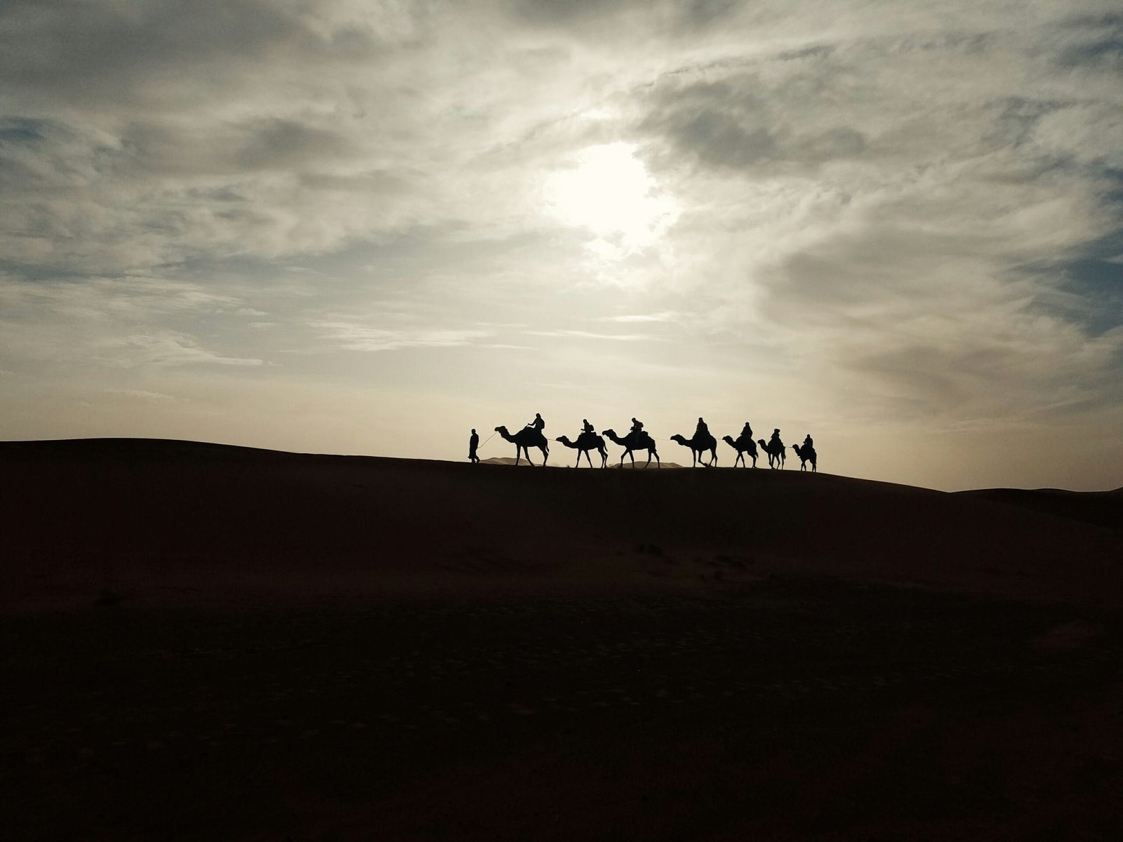 ourist enjoying a camel ride in the Agafay Desert during a traditional Moroccan desert experience