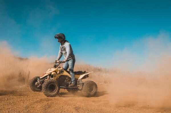 Tourist riding a quad bike through the rocky trails of the Agafay Desert near Marrakech