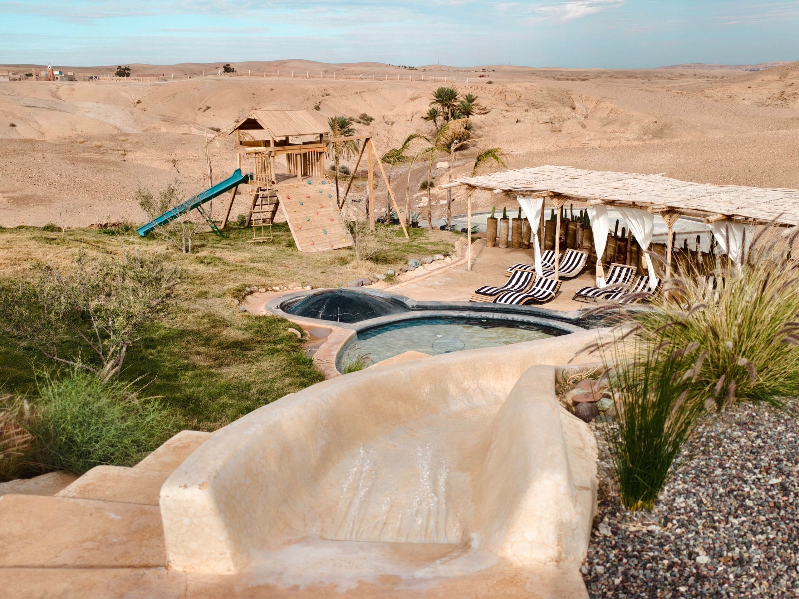 Be Agafay terrace and pool area with desert plants and the Agafay hills