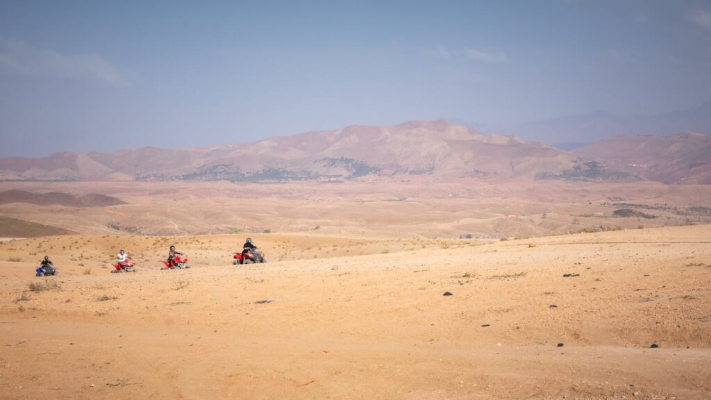 Group of quad bikers exploring the vast Agafay desert near Marrakech, Morocco.