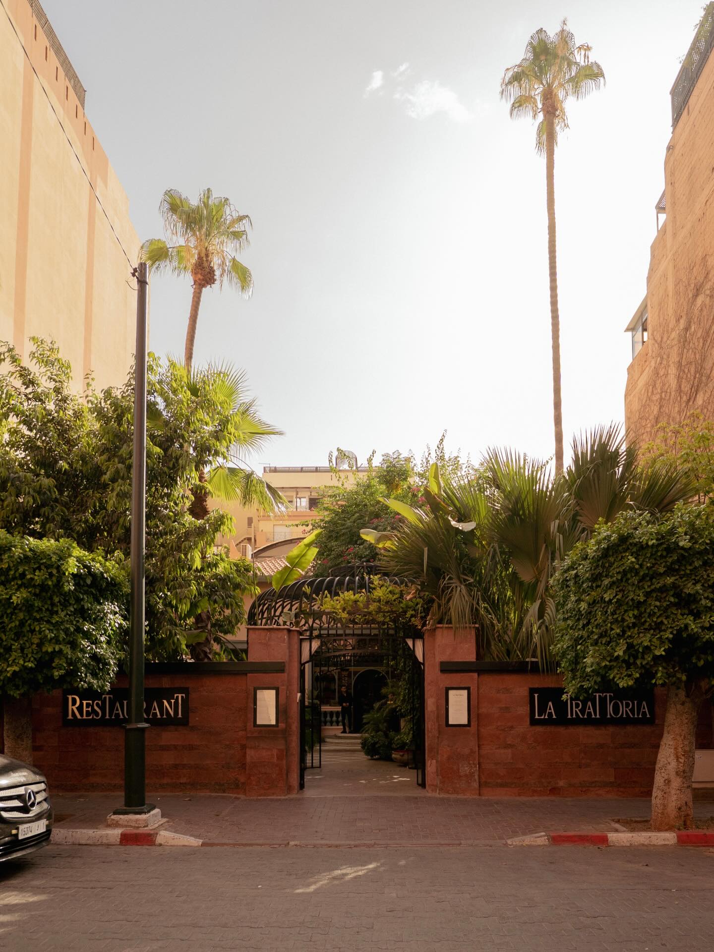 La Trattoria Marrakech poolside ambiance with glowing Moroccan lanterns at night