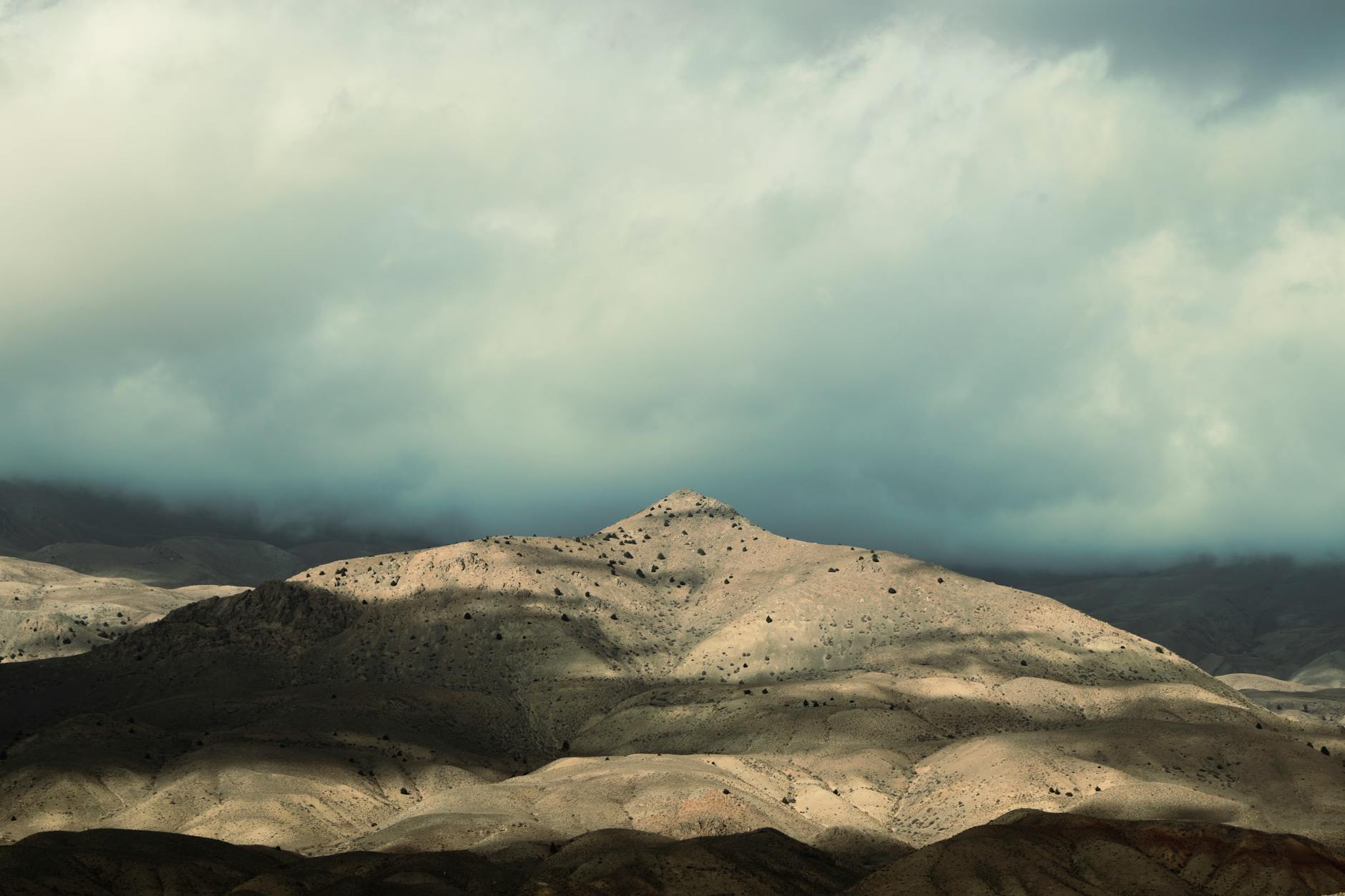 A stunning sunset over the stone dunes highlighting the Agafay desert weather in April - July