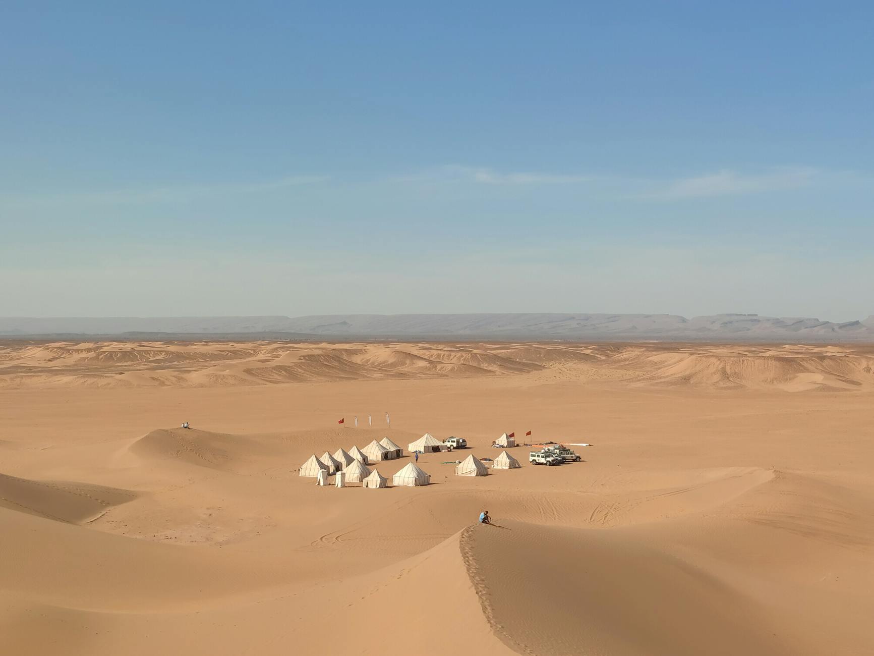 A beautiful stone-designed infinity pool overlooking the arid Moroccan hills during an agafay desert luxury camp day pass experience.