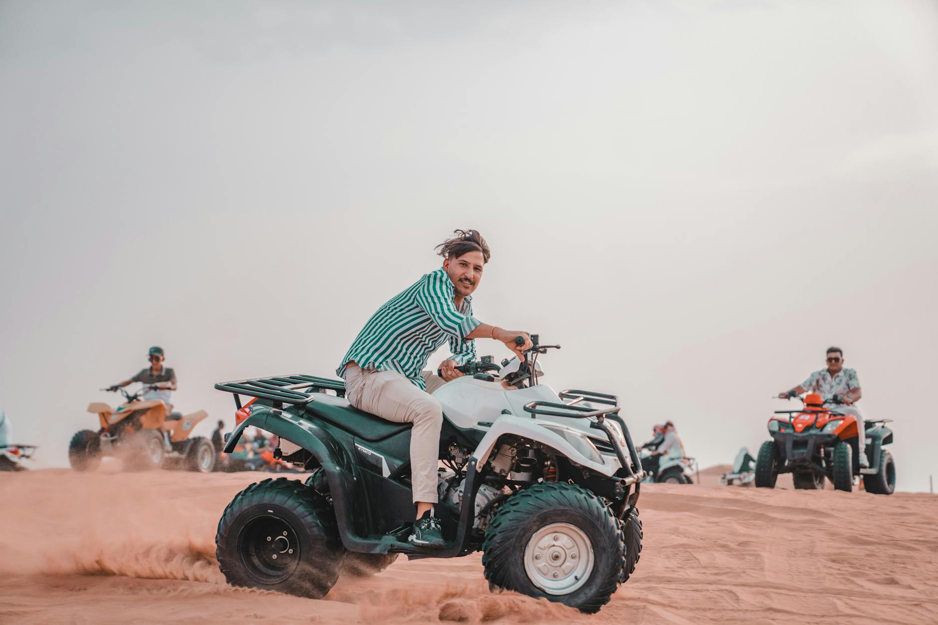 An adventurer riding a quad on a private quad bike tour agafay desert under a clear sky