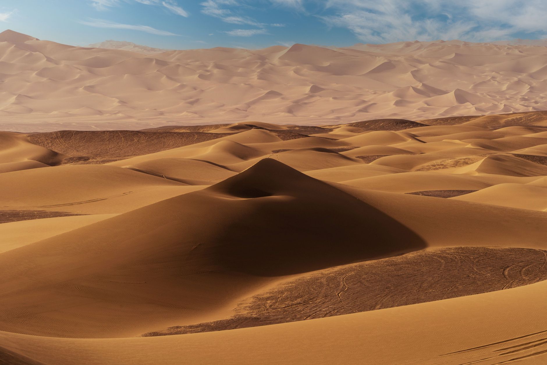 Golden sunset over the stone dunes of the Agafay Desert, showing the best time to visit agafay desert