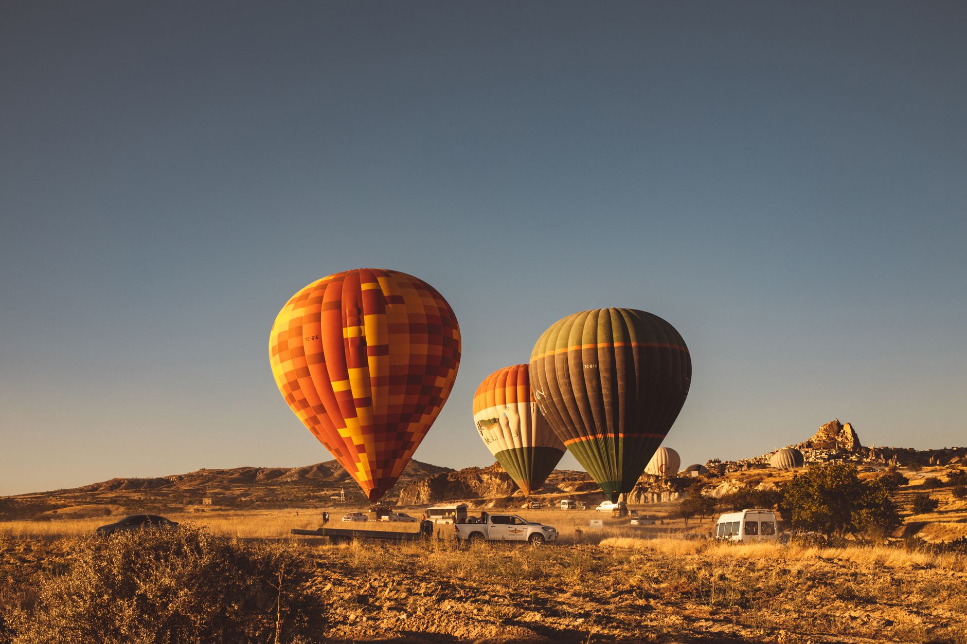agafay desert 2 days 1 night with hot air balloon - Hot air balloon flying over the stony hills of the Agafay Desert at sunrise