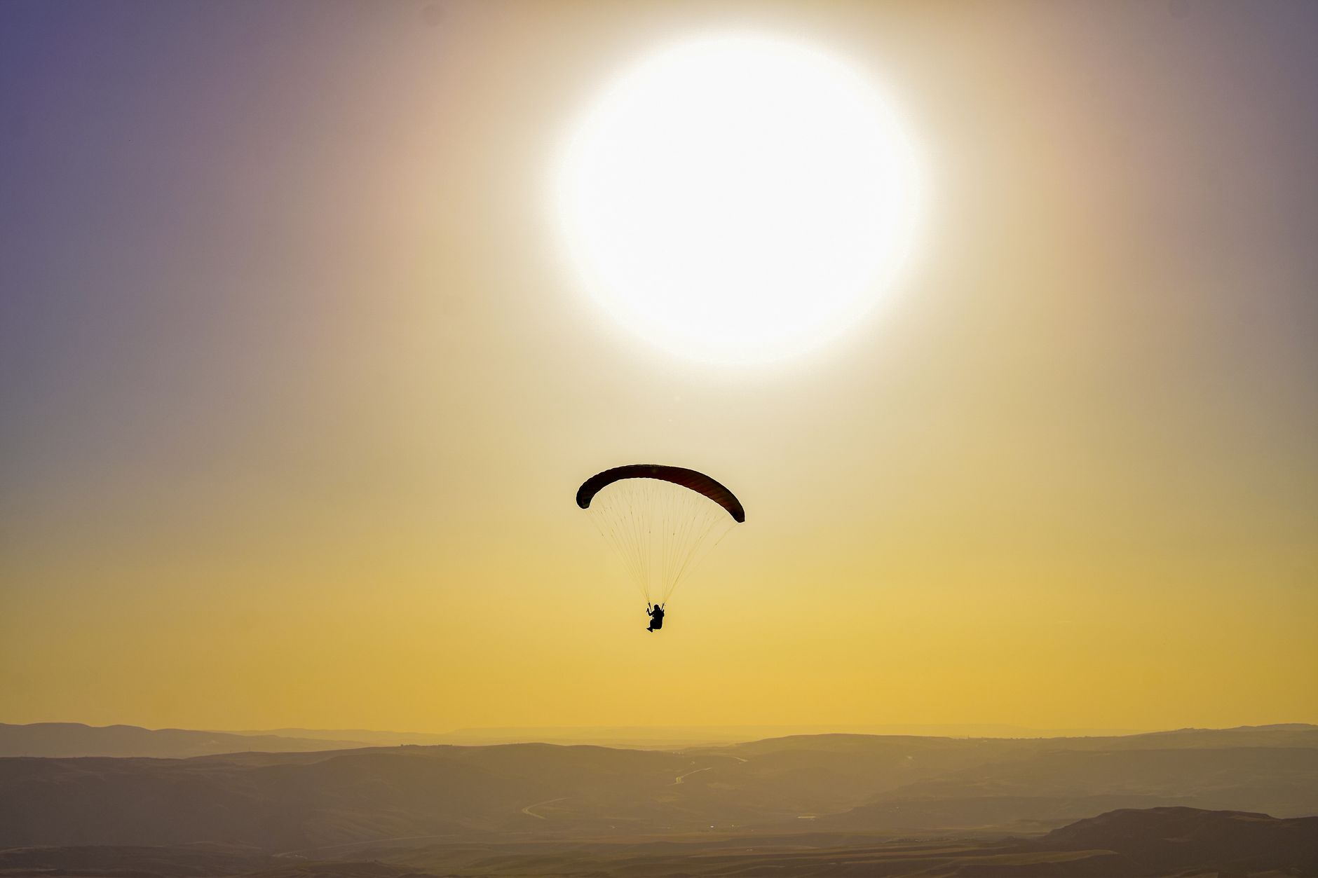 Tandem paragliding in agafay marrakech over the stone desert hills